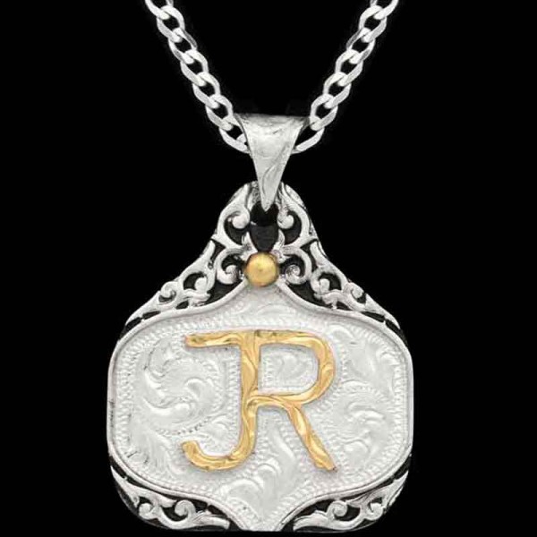 Holmer, German Silver base 1.75"x1.50" hand-engraved scrollwork. Jewelers Bronze Ranch Logo and bead. All framed with black enamel.

Chain not included